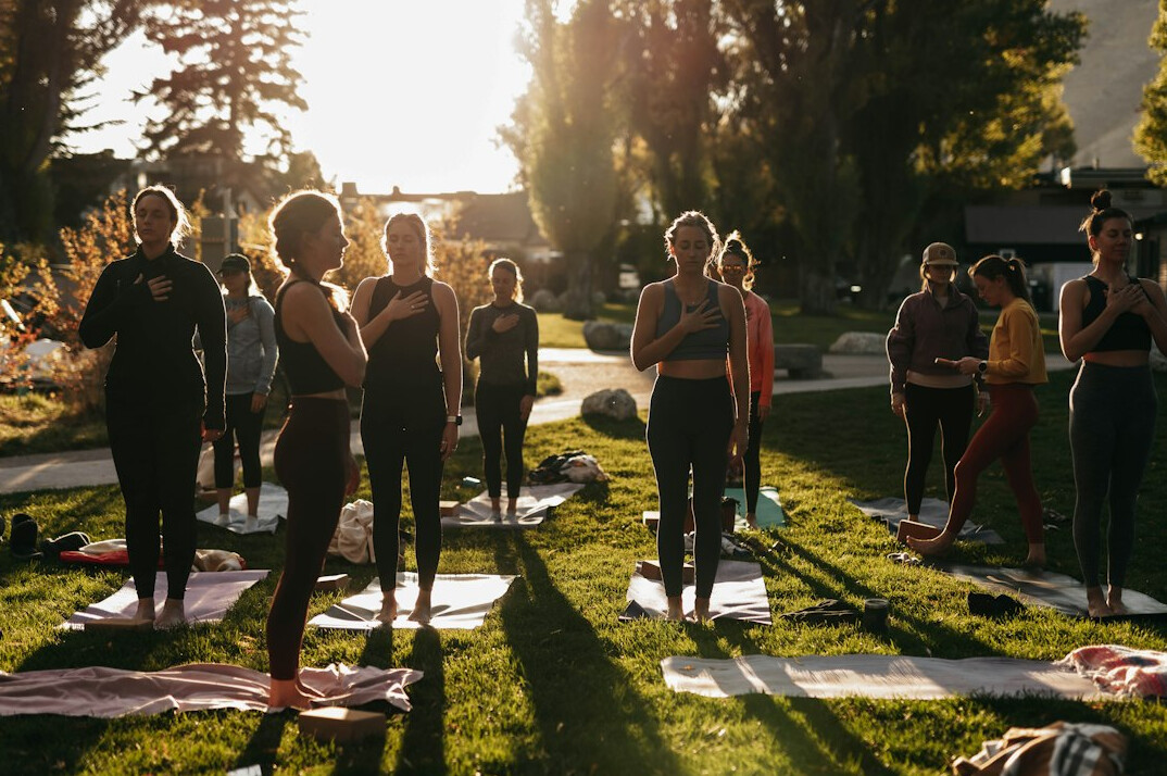 Group of diverse active seniors laughing outdoors during a fitness class