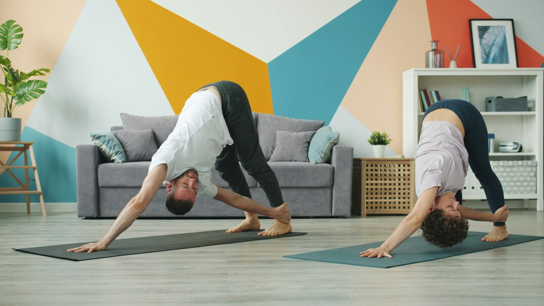 Senior citizens practicing yoga together in a bright studio